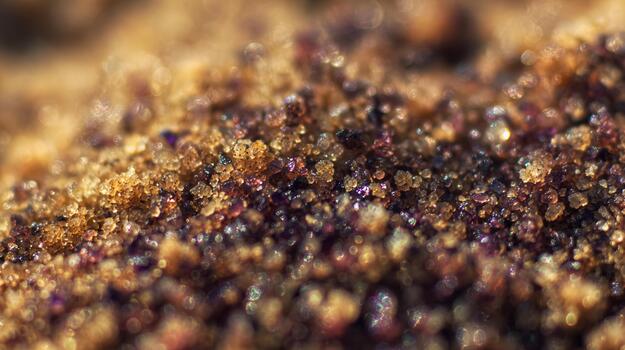 Close view of colorful sand grains mixed with minerals in a natural setting photo
