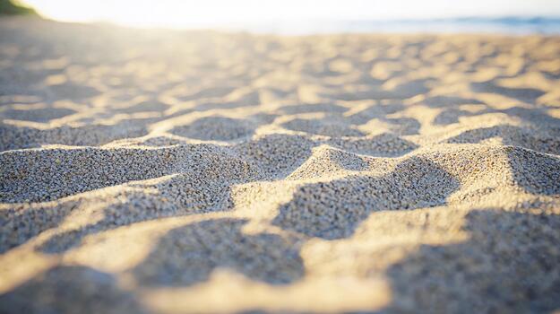 Morning shadows on sandy beach create subtle textures in tranquil setting photo