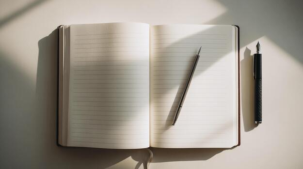 Flat lay of an open notebook and pen on a table, perfect for writing ideas photo