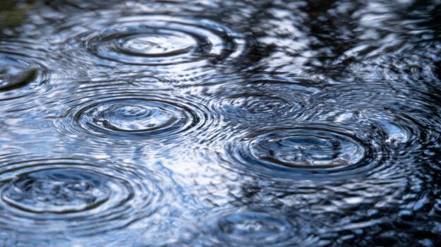 Beautiful ripple patterns on water surface during a rainy day photo