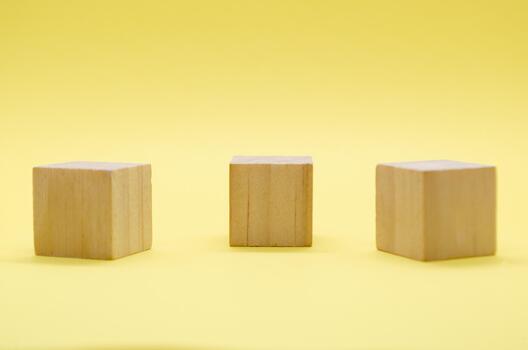 Close up view of isolated wooden cube with customizable space for text or ideas on yellow background. Copy space concept photo