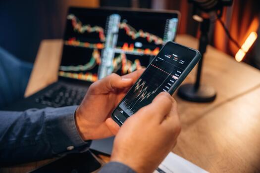 Person analyzing stock data on smartphone photo