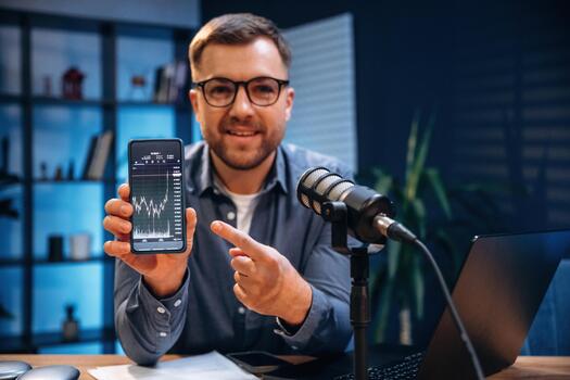 Person showing smartphone with financial chart photo