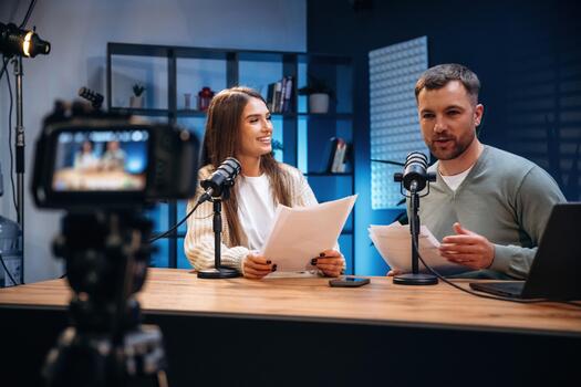 Podcast hosts with scripts on a table photo