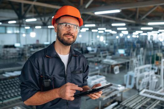 Worker in safety gear using a tablet photo