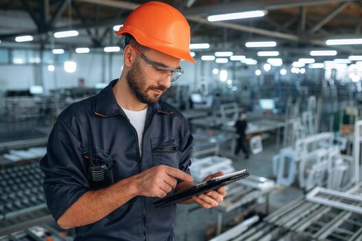 Worker with tablet in factory photo