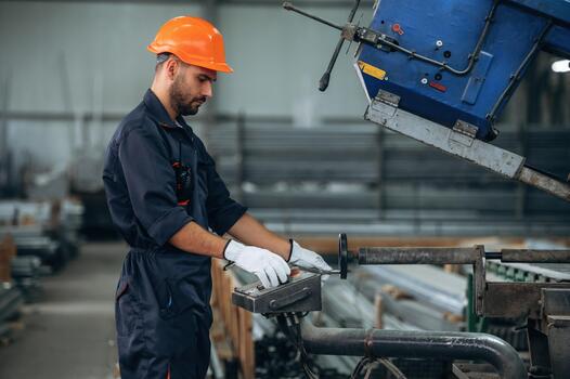 Worker operating machine in factory photo