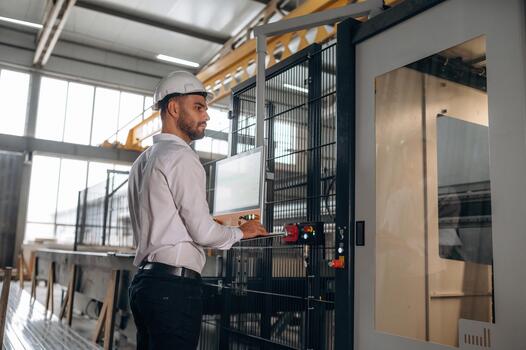 Operator at industrial machine controls photo