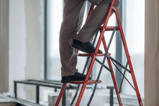 Man standing on a ladder photo