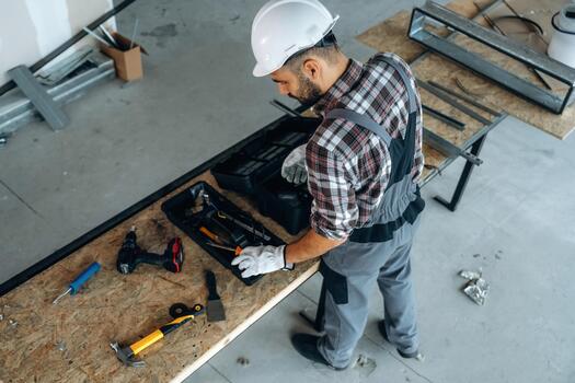 Worker with tools on a construction table photo