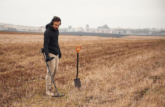 Man searching for treasures in a field photo