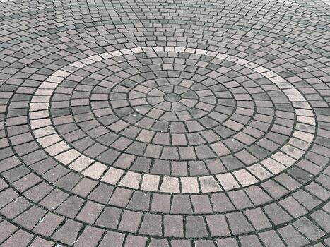 Circular Pattern of Paving Stones in a Symmetrical Design on a Sidewalk with Earthy Tones Perfect for Urban and Architectural Themes photo