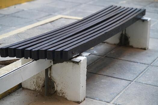 Minimalist Urban Wooden Bench in an Outdoor Setting, Perfect for Relaxation and Public Spaces, Showcasing Simple Design Elements and Texture photo