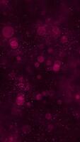 Abstract animation with shiny particles and shimmering bokeh light on a dark magenta vertical background. This luxury background is perfect for romantic, celebration, or luxury themes. video
