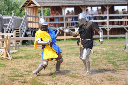 Two knights are fighting in armor with swords, reconstruction of the tournament. A scene with spectators from a log house. Celebration of the pagan day of Ivan Kupala photo