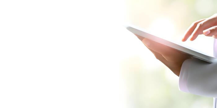 A person works with a modern digital tablet device using their fingers to interact with the screen photo