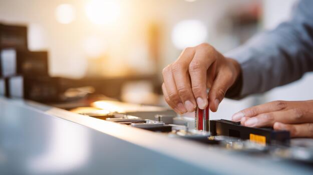A focused male technician carefully installs memory modules into a computer motherboard, showcasing precision in a tech workspace. photo