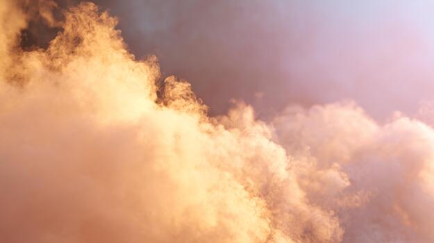 Soft golden clouds illuminated by warm light create a serene and dreamy atmosphere. photo