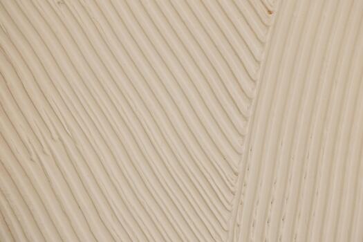 Textured surface shows smooth lines in off white color creating an artistic effect photo