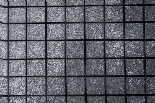 Grid pattern on a dark surface in an indoor setting during the day photo