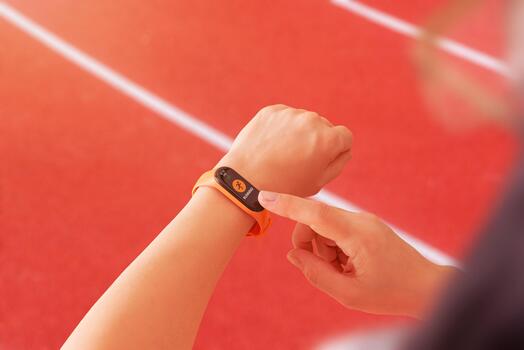 Smart band set to running mode on an athletic track, emphasizing sports performance monitoring and active training routines photo