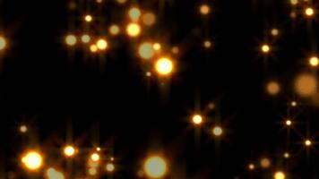dorado bokeh luces flotante en negro antecedentes resumen movimiento gráficos. video