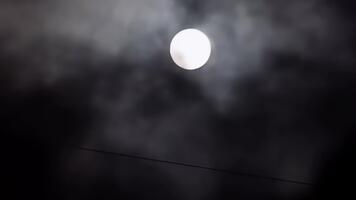 Mysterious Bright Full Moon Partially Obscured by Dark Clouds and Fog video