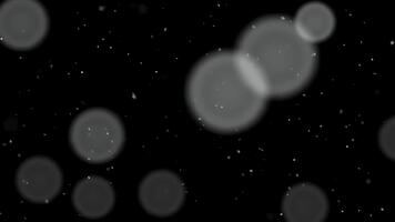 resumen bokeh burbujas y polvo partículas flotante en oscuridad con sutil ligero brilla video