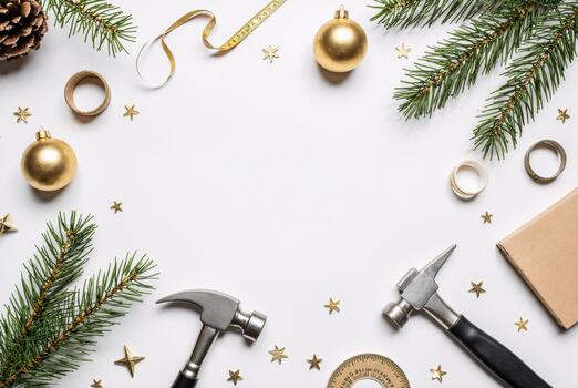 Festive workspace scene with tools and evergreen branches on white backdrop, seasonal construction mood photo
