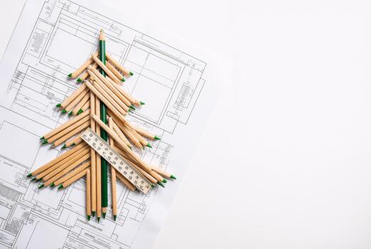 Creative Christmas tree made of pencils and ruler on architectural blueprints, festive design concept photo
