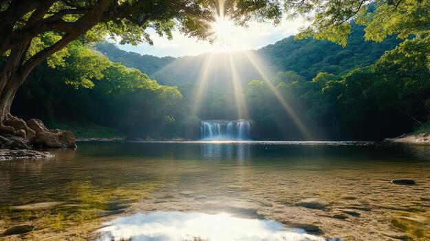 A waterfall in the middle of a forest with sun rays shining through the trees photo