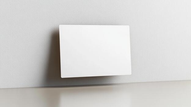 A square piece of paper on a wall photo