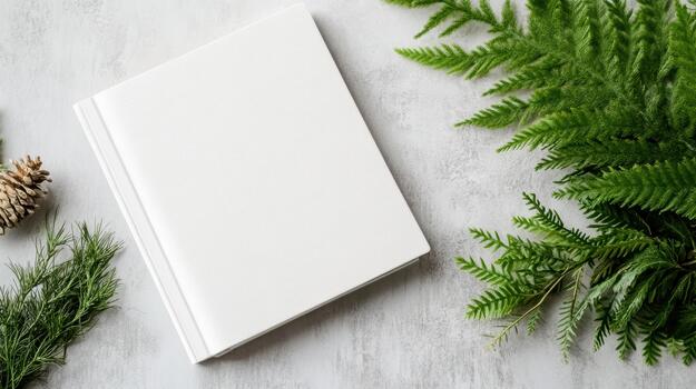 Blank white notebook with green ferns and pine cones on a white background photo