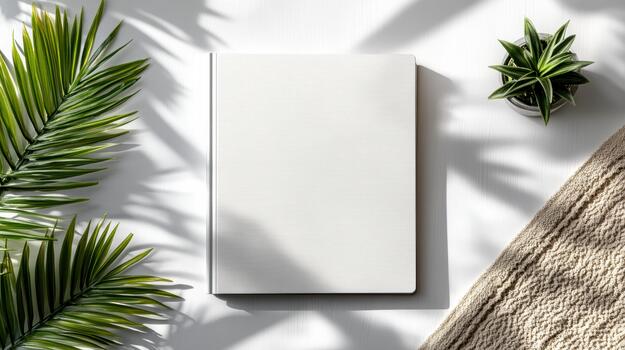 Blank notebook with palm leaves on white background photo