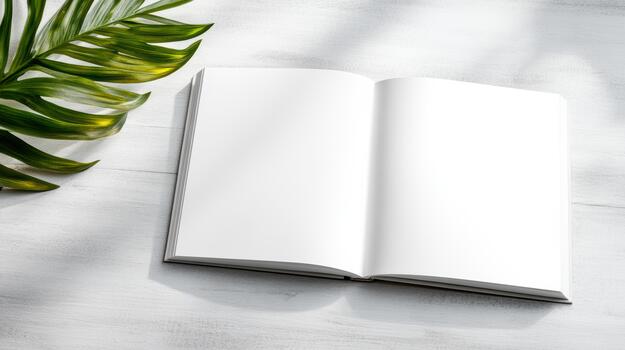 Open book with palm leaves on white wooden table top view photo