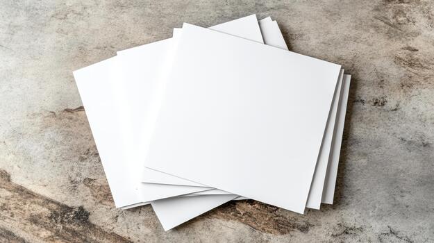 A stack of blank paper on a concrete surface photo