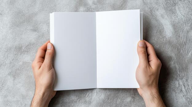 Hands holding open blank book on concrete background photo