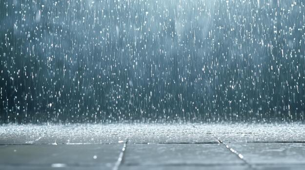 Rain falling on a tile floor with a light shining on it photo