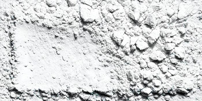 A textured white powder background featuring crumbled pieces and a smooth rectangular area ideal for design elements or text photo