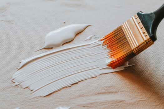 Brush With White Acrylic Paint Spreading Across Textured Canvas In A Bright Studio photo