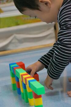 Child's hands building a structure using colorful blocks. This scene highlights creativity, learning, and play with colorful blocks. photo