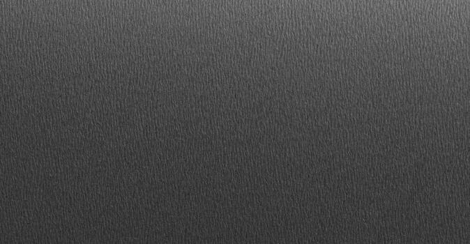 Black paper surface with fine texture and matte finish, minimal dark background for design projects, photo