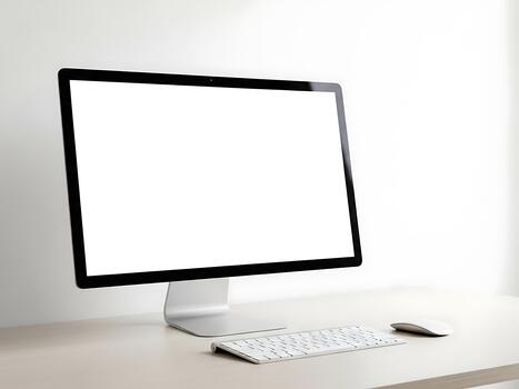 A computer monitor sitting on a desk with a keyboard and mouse photo
