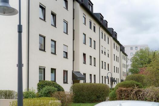 Residential building with modern architecture featuring greenery in urban setting during cloudy day photo