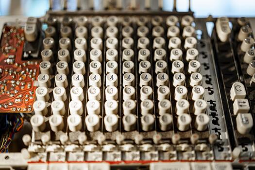Vintage calculating machine displaying numerous numbered buttons in intricate arrangement on an outdated circuit board photo