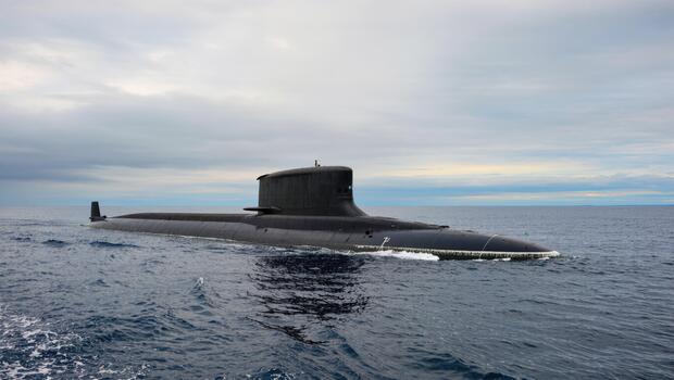 Advanced Submarine Gliding Through Calm Ocean Waters Under a Cloudy Sky photo