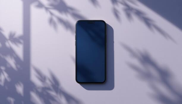 Smartphone Resting on a Flat Surface Shaded by Tree Leaves During Daylight Hours photo