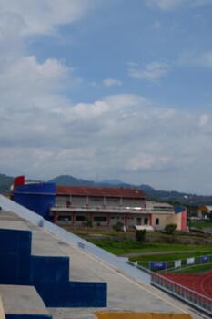 Soft Focus Stadium with Mountain View and Cloudy Sky Landscape photo
