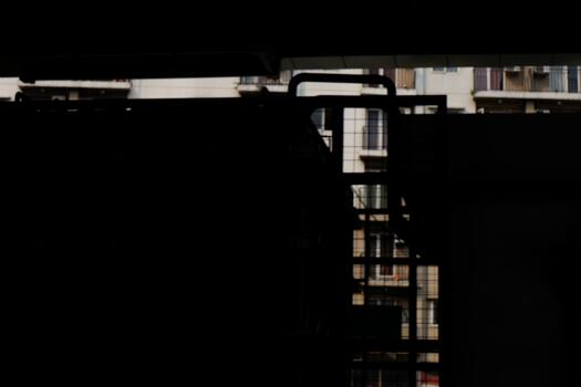 Dark View of Apartment Buildings Through Metal Structure Abstract Architecture photo