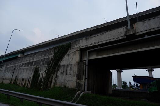 Urban Concrete Overpass Structure with Green Vegetation Underneath Architecture photo